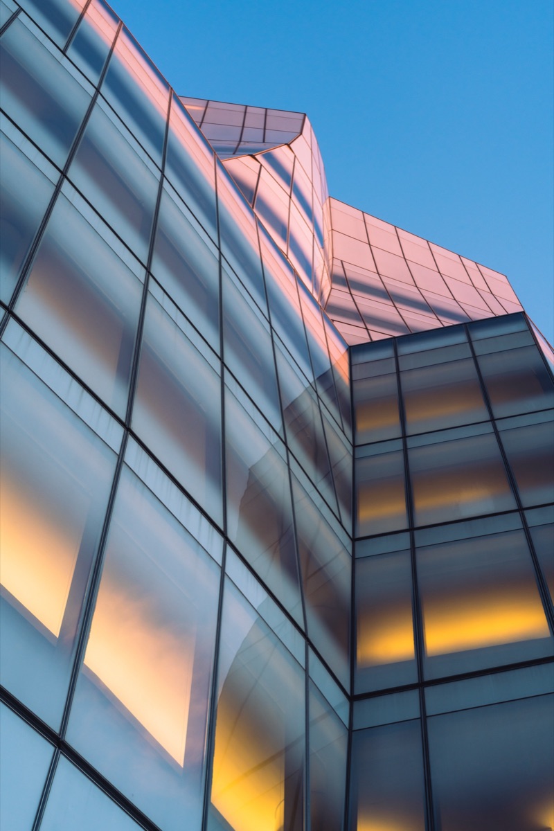 Sunset reflected across the angled glass facade of the IAC Building, New York