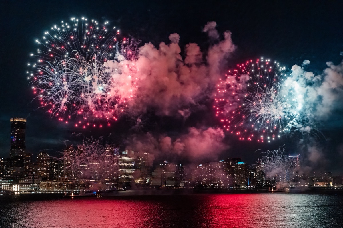 Fourth of July fireworks bursting over the Hudson River and the Jersey City skyline
