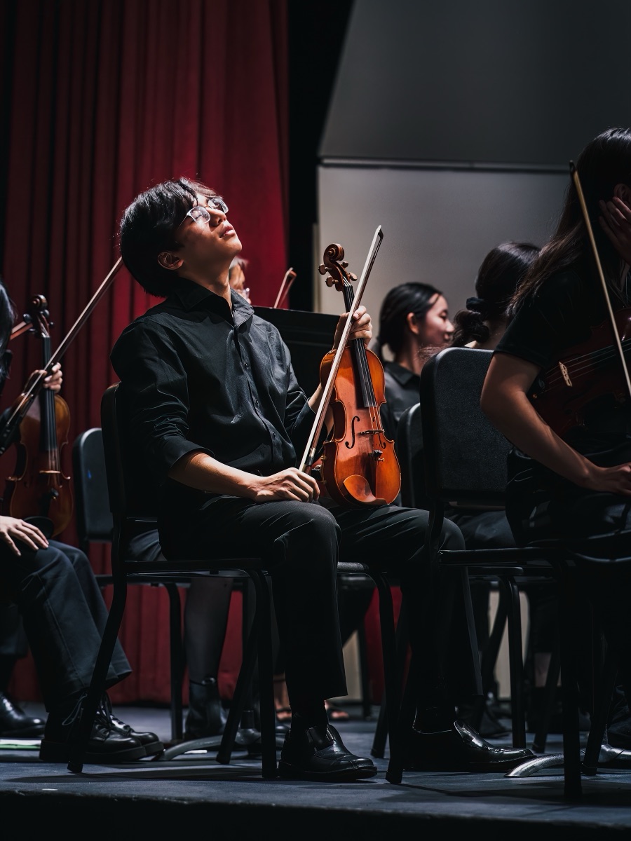 A violinist looking up between movements during an orchestra concert